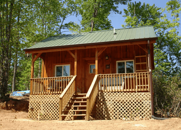 16x20 Vermont Cottage Option A with insulated windows, porch railing, lattice coverup under porch and client built stairwell.