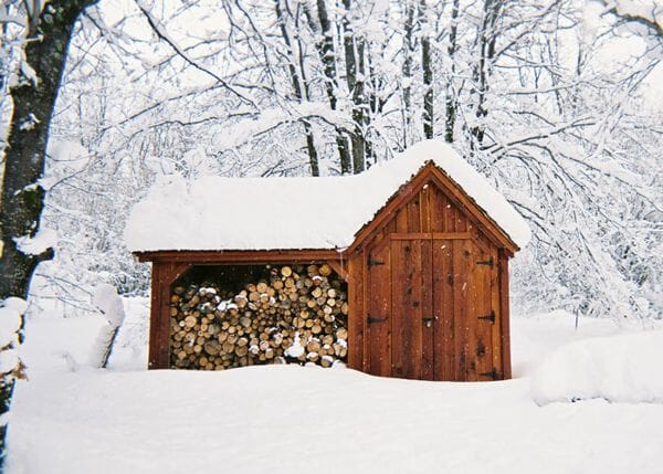 This small firewood storage shed doubles as recycling storage. This multipurpose function provides additional value. 