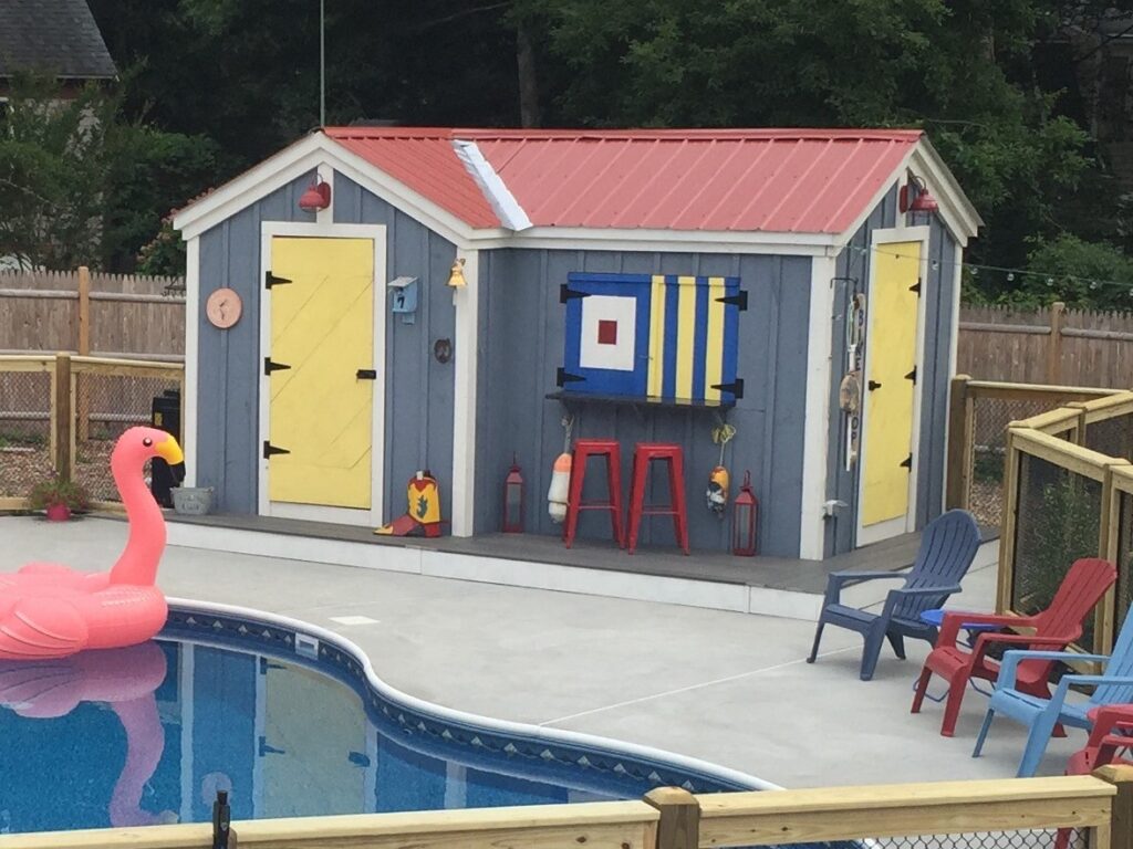 Painting a storage shed with vibrant hues will create a festive, summer atmosphere. 