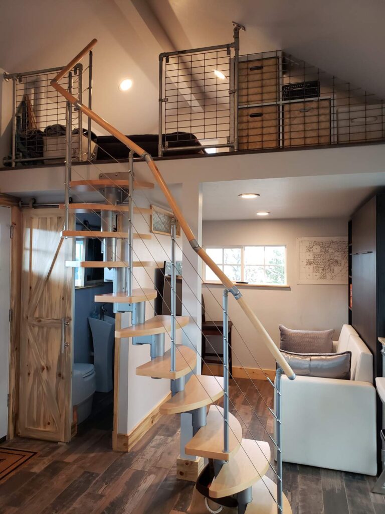 This beach house interior has a custom built staircase to the lof.t 