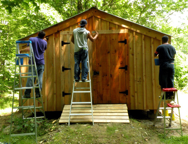 Three friends work together to get their barn painted. 
