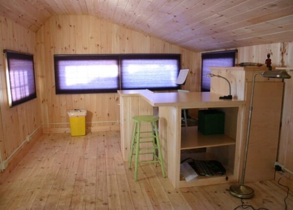This insulated storage shed is being used as a backyard recording and practice studio for musicians.