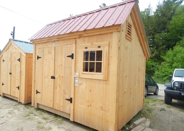 Small 80 square foot storage shed with a red metal roof.