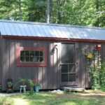 Custom built 12x20 (240 square foot) storage shed painted brown with red trim.