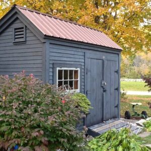 8X10 Storage Shed with clapboard pine siding and a red metal roof.