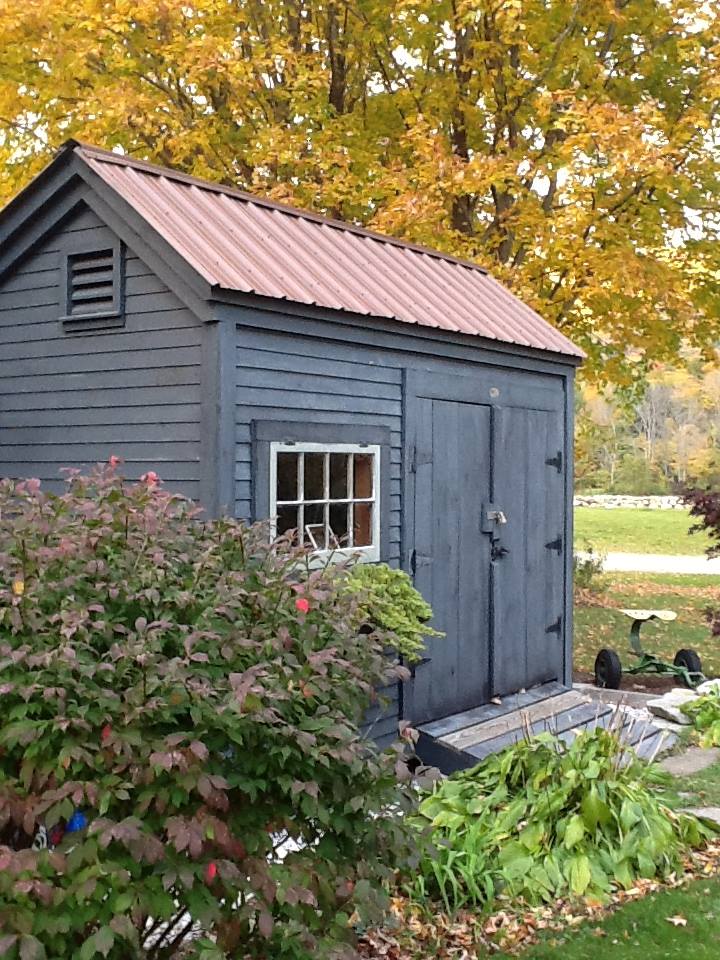 8X10 Storage Shed with clapboard pine siding and a red metal roof.