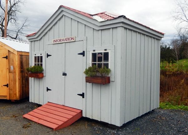An upgraded tool shed with autumn red roof, flower boxes and paint