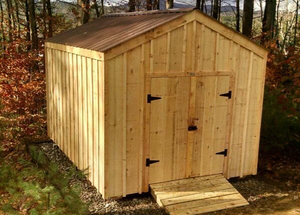 Upgrades shown on this New Yorker shed are pine battens and a tudor brown metal roof