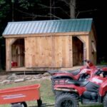 10x16 Three Sled Shed - Shown with sliding barn doors opened