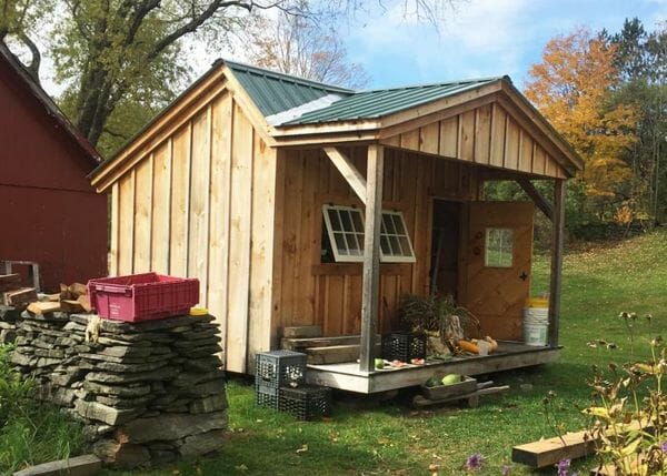 12x12 Potting Fort is a unique garden shed that includes a covered porch, single door and a few hinged barn sash windows