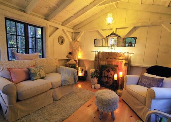 This post and beam cabin was decorated with a sofa, armchair, antiques and other housewares
