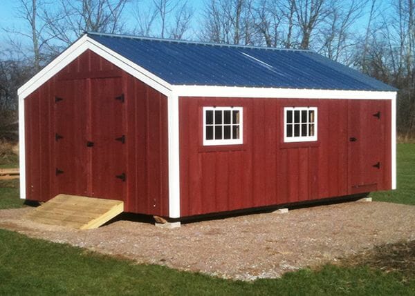 14x20 Barn that has been painted, with a matte black roof, windows and an extra door.
