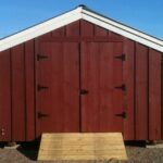 14x20 Barn that has been painted red with white trim