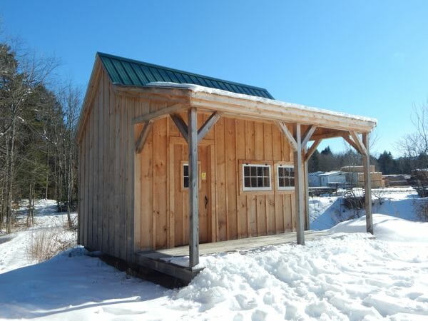 16x16 Homesteader is a tiny house that includes a spacious porch