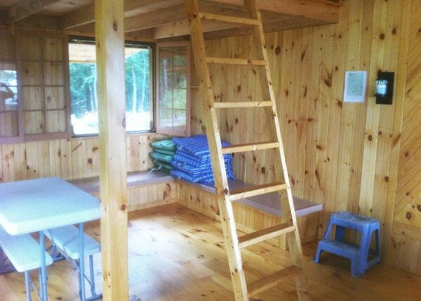 16x20 Vermont Cottage Option B includes a loft with ladder. This one has been finished out with interior sheathing