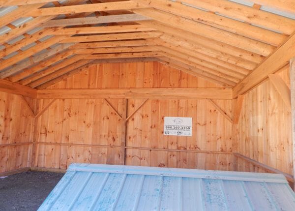 The two bay simple garage is constructed of a post and beam hemlock frame on a pressure treated sill plate. A concrete slab foundation is recommended.