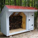 4x10 Weekender firewood storage shed customized to have red metal roof and painted blue