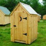 4x4 Outhouse Shed with metal roof, board and batten siding and door with moon cut-out