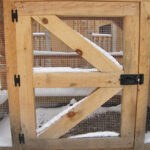 Side door constructed of pine and hardware cloth, fastening hardware included.