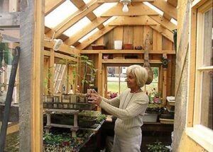 6x8 Greenhouse being used by a skilled gardener