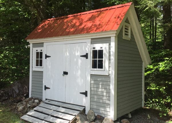 8x12 Saltbox storage shed customized with a red metal roof and clapboard siding