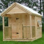 8x12 Garden Shed with clapboard siding, clearpoly roof, porch railing with half newel posts and larger hinged windows