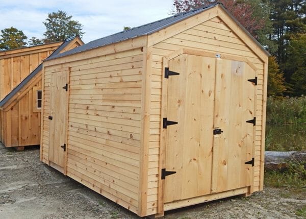 This 8x12 New Yorker Option B garden shed was modified to have an extra door, clapboard siding and a black roof