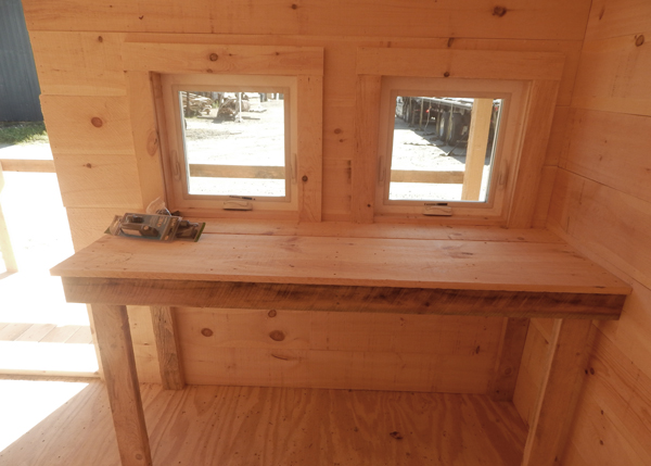 built-in workbench inside a potting shed.