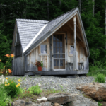 12x14 Writers Haven post and beam cottage with screen door, fifteen lite wood door and red cedar shingle roofing