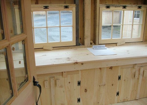 Bayside workshop interior with custom built in worktable with cabinets