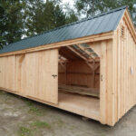 5' JCS Built 2" thick Pine Sliding Barn Door on 12x20 Three Sled Shed.  Exterior view.  Black Drop latch.