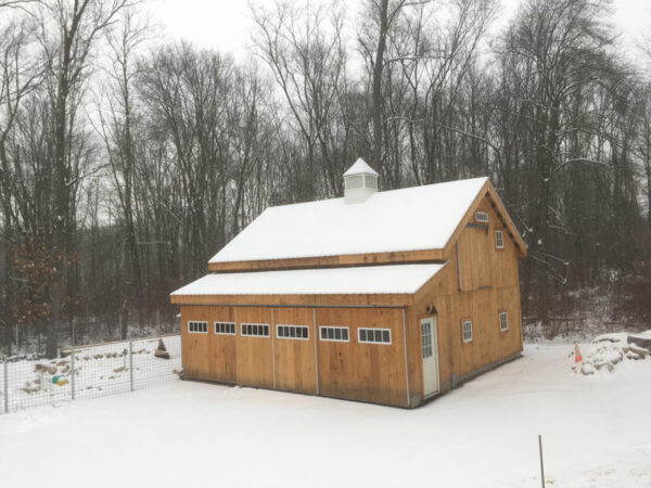 Enclosed overhang built with 8x8 Construction on a 20x30 Barn.
