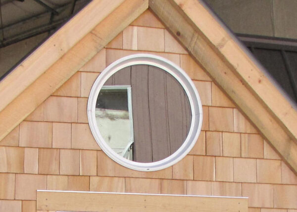 The 24" diameter insulated window adds a nice touch in the gable of a cabin.