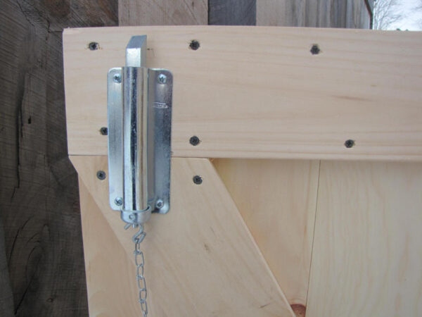 The chain bolt is installed near the top of the door to keep one door closed when not in use.