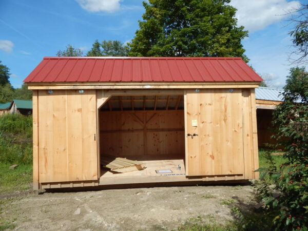 5' JCS Built 2" thick Pine Sliding Barn Door on 10x16 Three Sled Shed.  Exterior view.