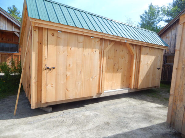 5' JCS Built 2" thick Pine Sliding Barn Door on 12x20 Three Sled Shed.  Exterior view.  Black Drop latch.