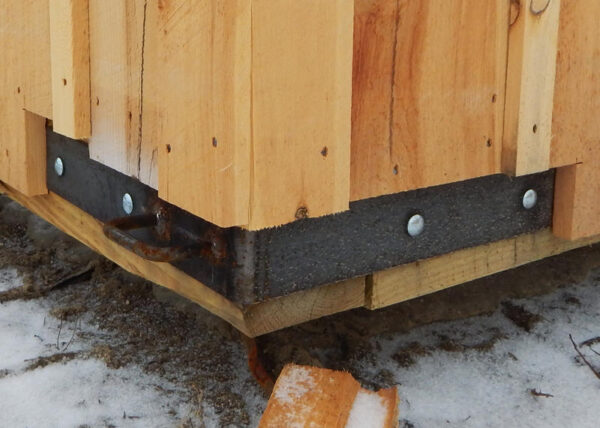 The heavy duty steel corner bracket with handle can be bolted on to any small post and beam building.