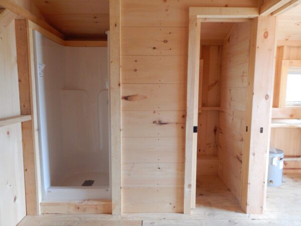 A shower and small room for an off-grid toilet option comes with this cabin.