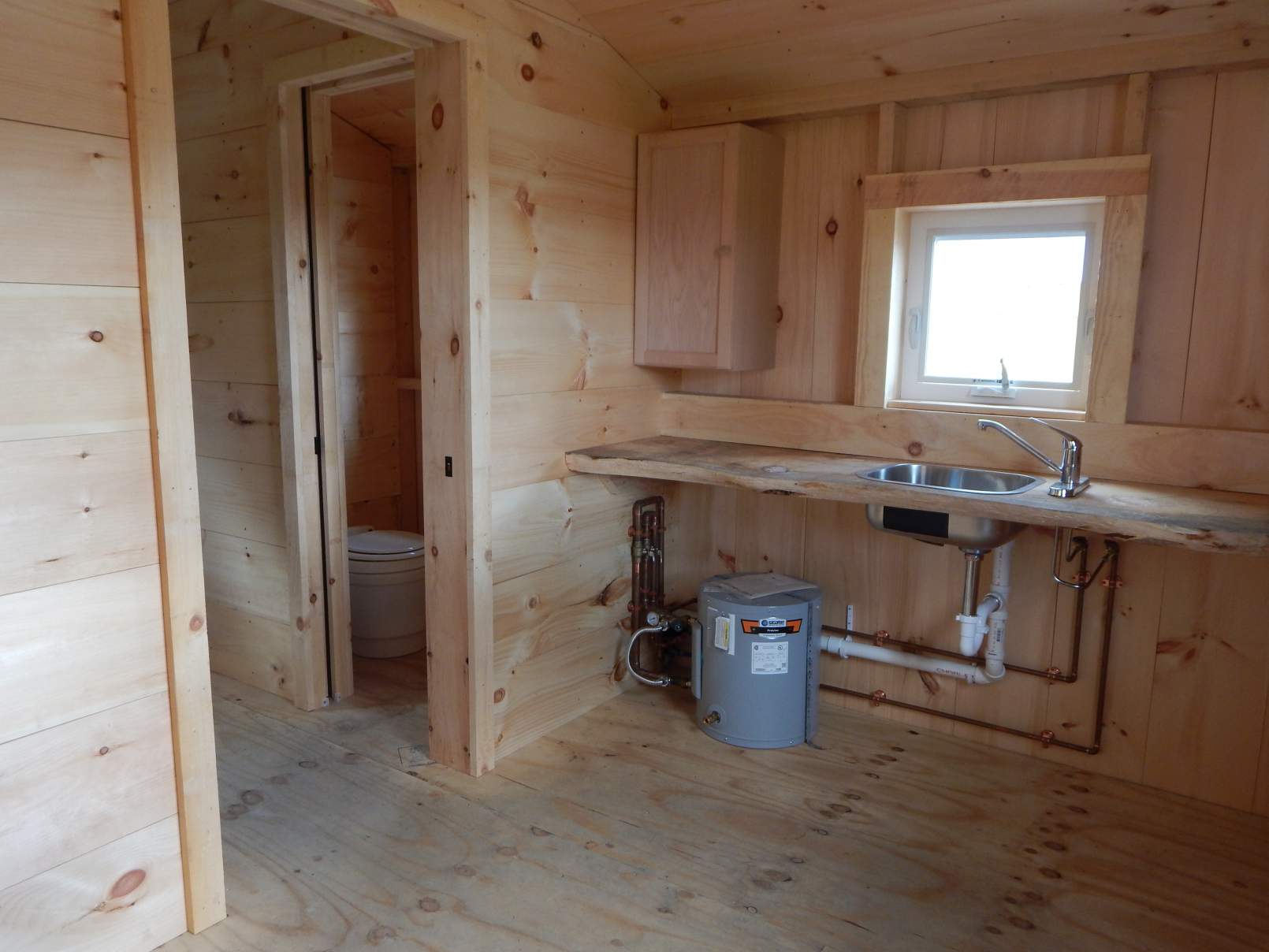 This simple cabin comes with a bare bones kitchenette and off-grid bathroom.