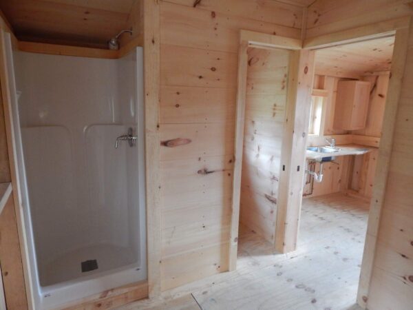 Tiny home with a kitchenette, shower and bathroom.
