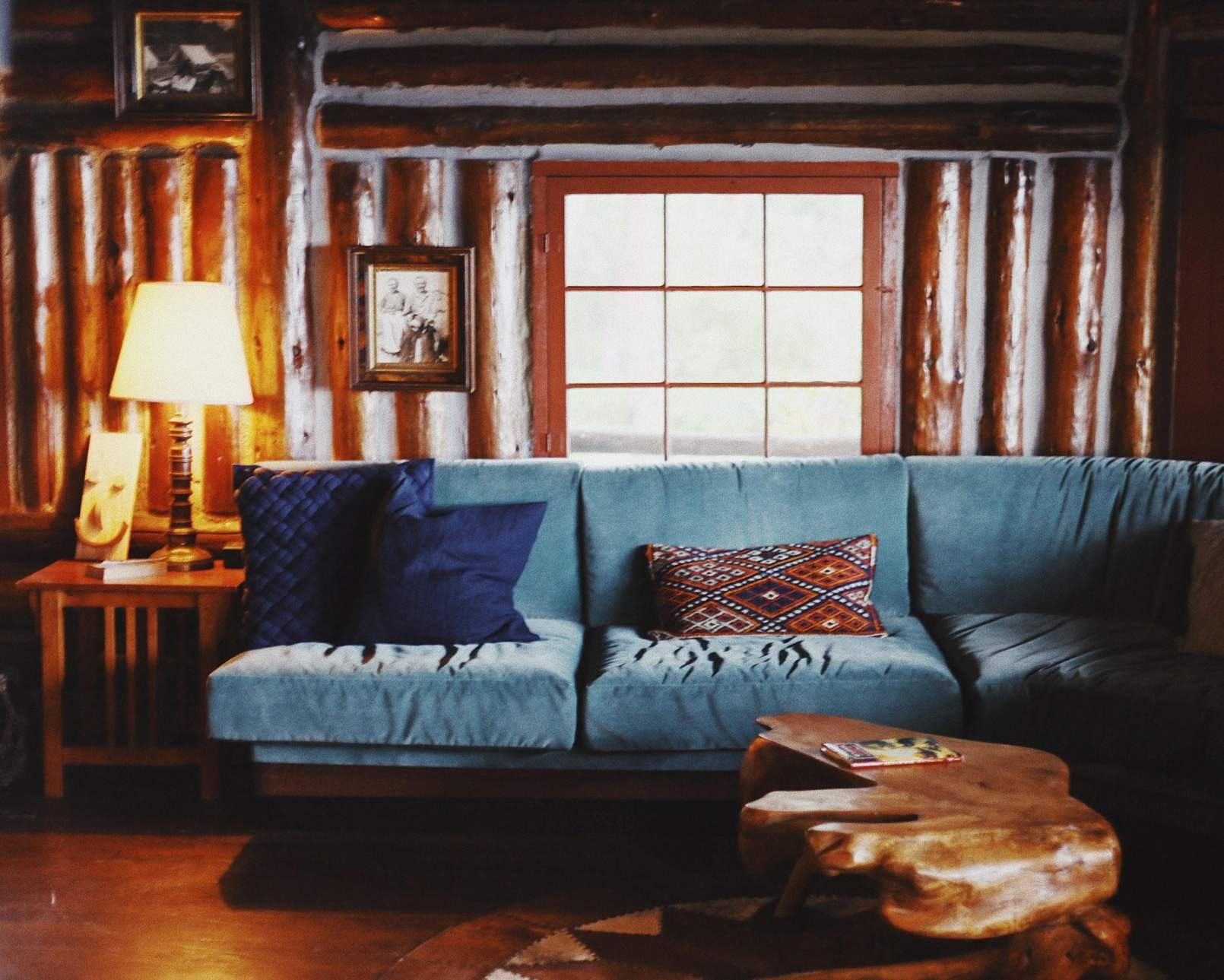 Rustic living room inside of a log cabin.