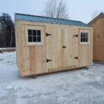 96 square foot storage shed with two windows and a double door.