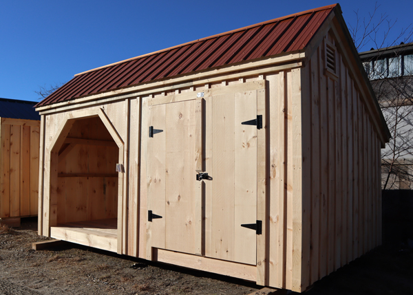 Backyard shed with enclosed storage and firewood storage.