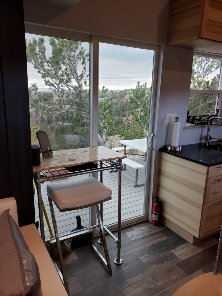 This small desk functions as a workspace or a place to eat, while enjoying the scenery. 
