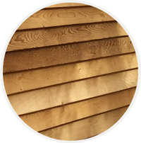 3/4"-thick Western red cedar clapboard siding of tiny home cottage or cabin.