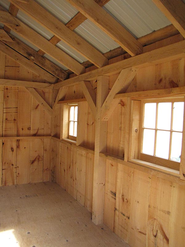Inside our 10x12 Gable shed you can see our post and beam hemlock framing and two barn sash windows.