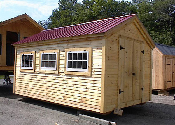This 10x16 Gable was custom built with extra shed windows, pine clapboard siding and an autumn red metal roof upgrade.