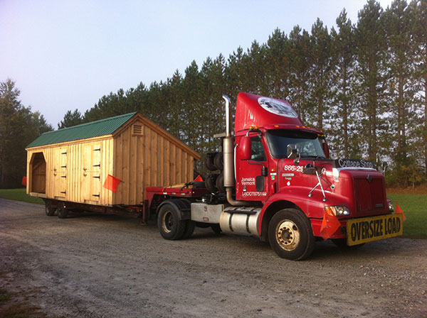 A fully assembled Stall Barn on the back of a delivery truck