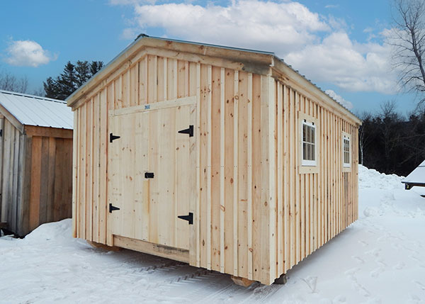 12x16 Gable shed built with standard options like board and batten siding, corrugated metal roof in Evergreen, double doors and two barn sash windows.