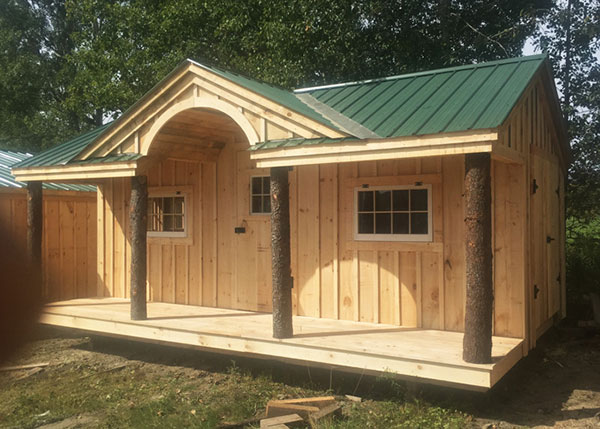 Unskinned hemlock posts are featured on this custom built cabin porch.